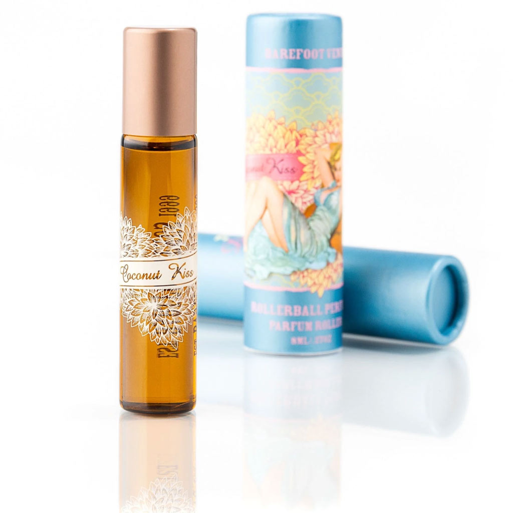 Barefoot Venus Coconut Kiss perfume oil roll on standing up with blue container in background with pin up girl in blue dress