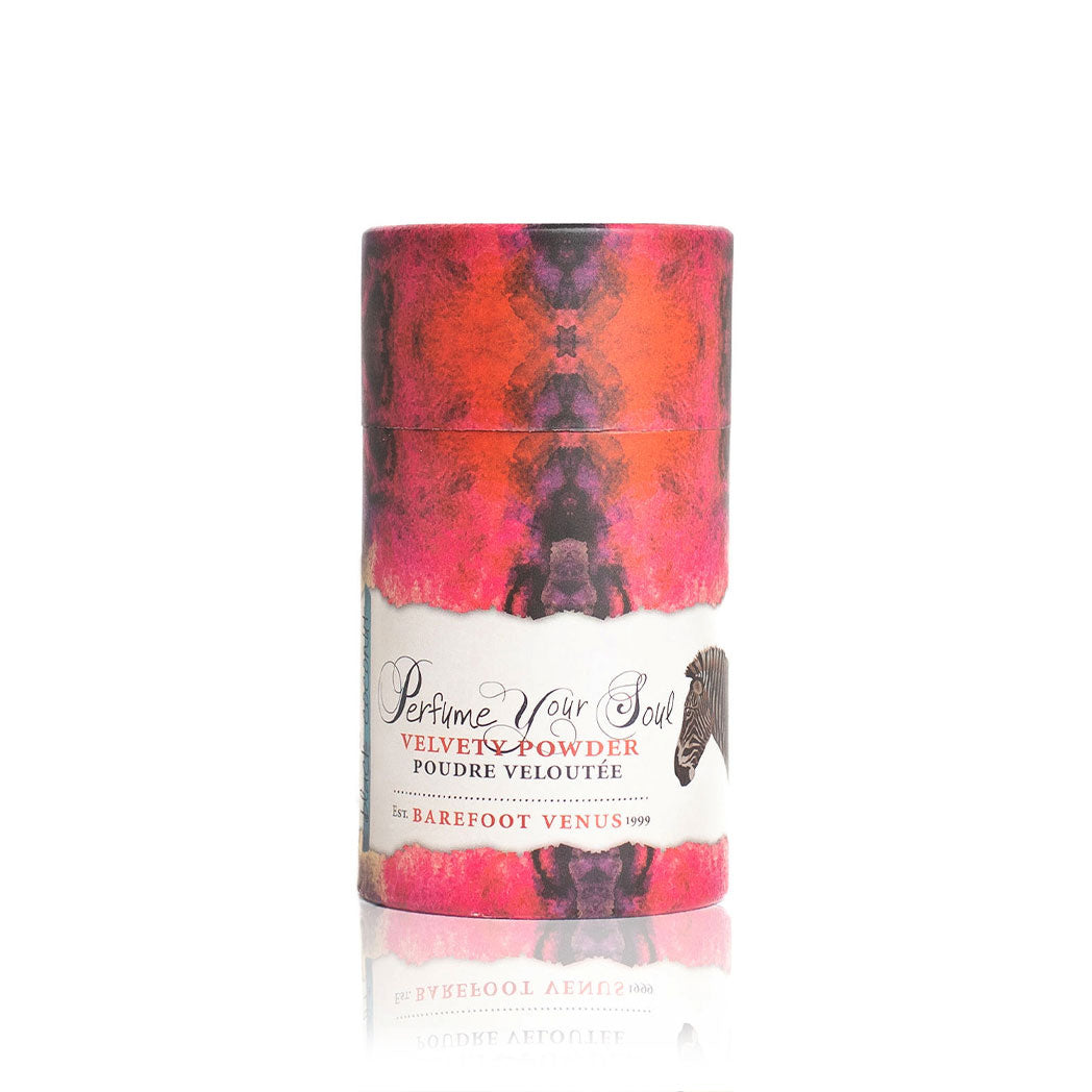 Barefoot Venus Black Coconut velvety powder on white background with pink and purple packaging with animal design on label.