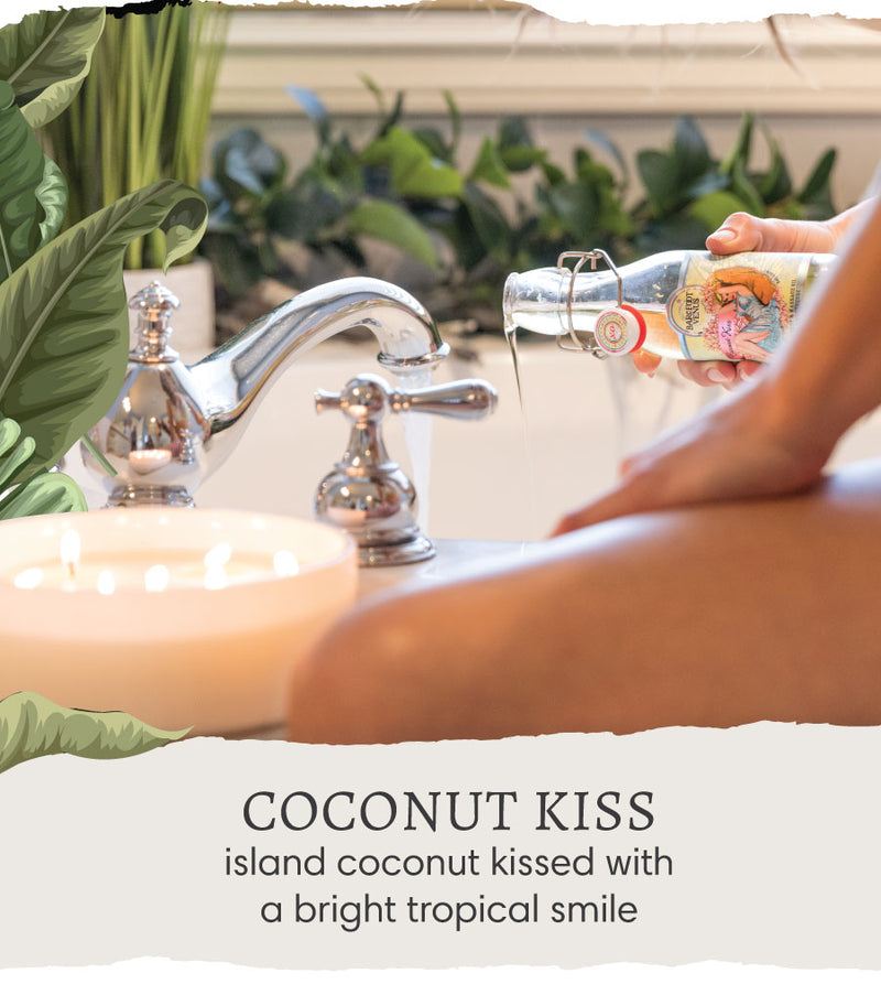 A woman pouring Barefoot Venus Coconut Kiss Massage and Bath Oil into her running bathtub with a candle burning beside the faucet. Text overlay reads "Coconut Kiss - island coconut kissed with a bright tropical smile".