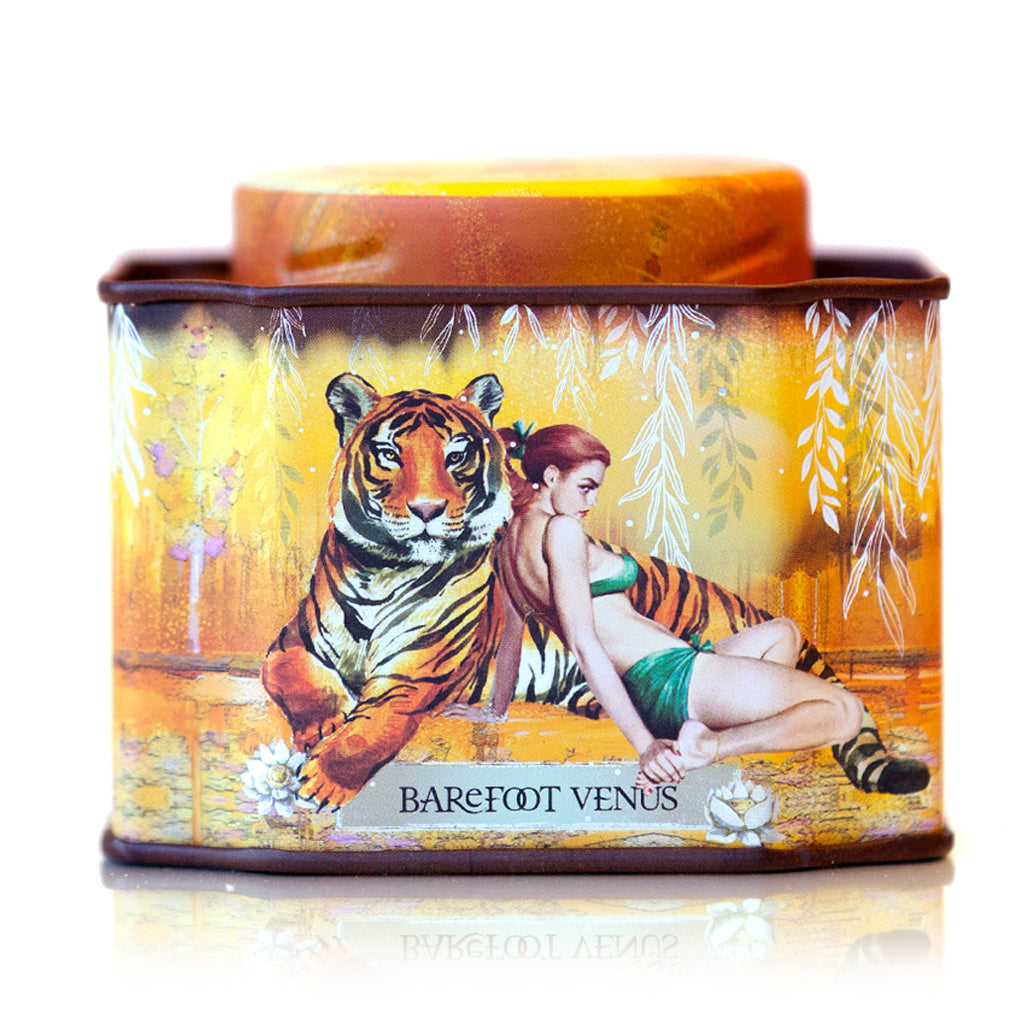 A tin of Apricot Brandy bath soak with a label featuring illustrations of a tiger and woman.