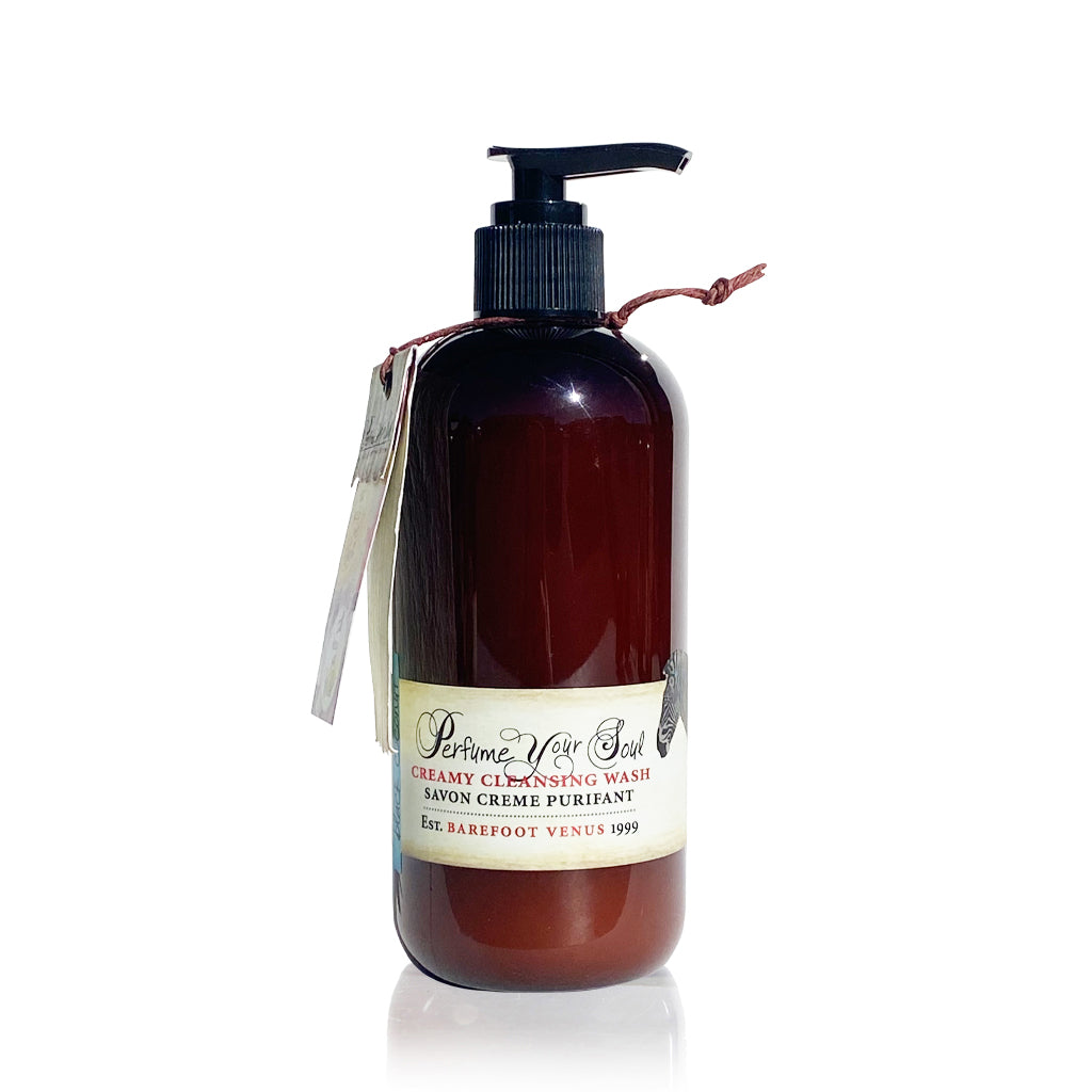A dark brown bottle with a pump dispenser of Barefoot Venus Black Coconut creamy cleansing wash.
