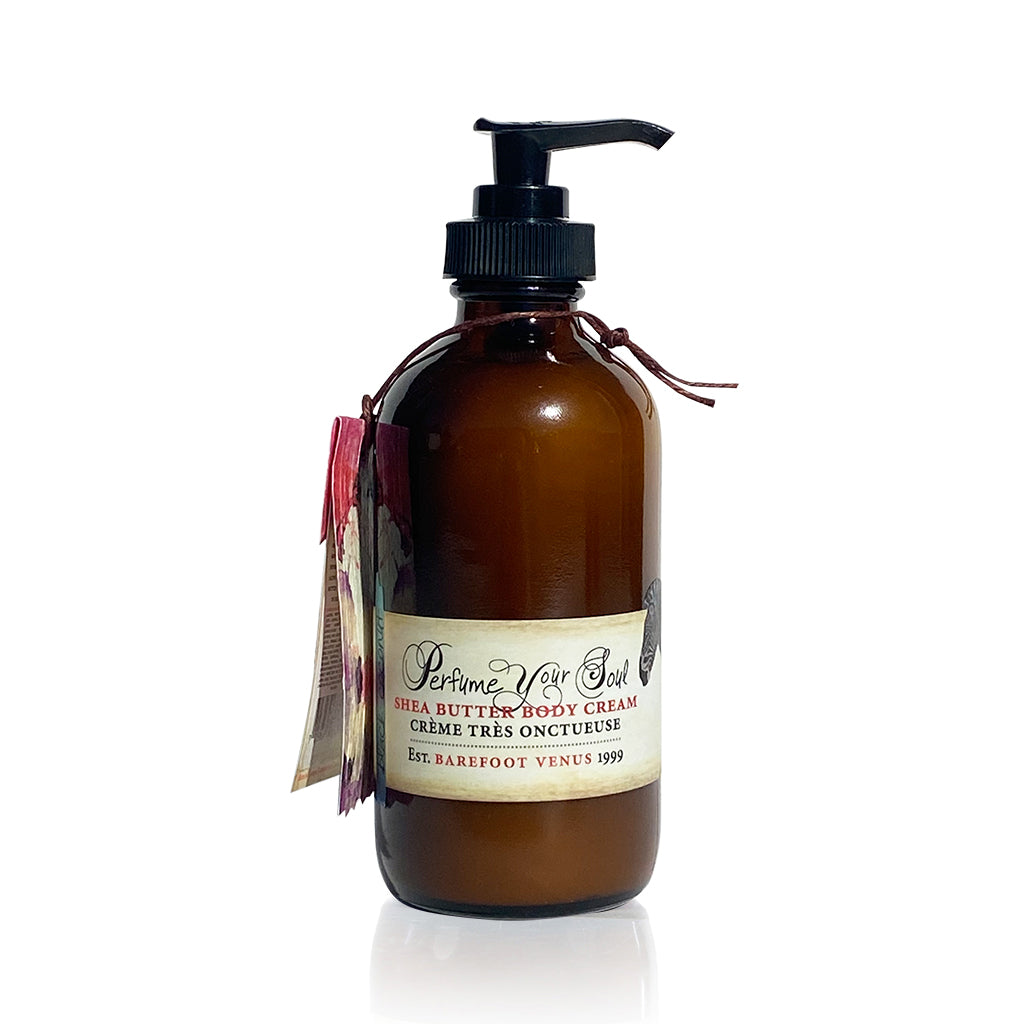 A dark brown bottle with a pump dispenser of Barefoot Venus Black Coconut shea butter body cream.