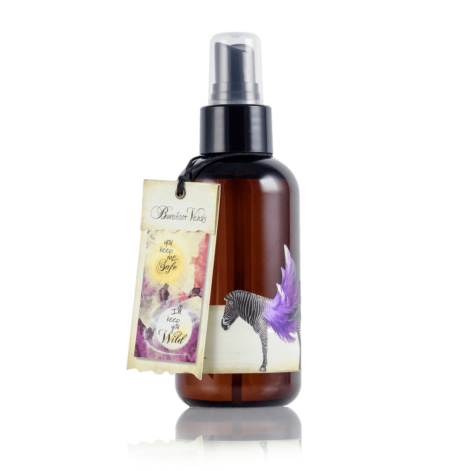 Person holding spray bottle of Barefoot Venus Black Coconut Argan body oil.